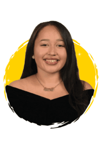 Fernanda wearing a nameplate necklace and a black off-the-shoulder top, set against a circular yellow background.